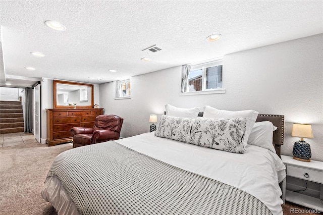 carpeted bedroom featuring a textured ceiling