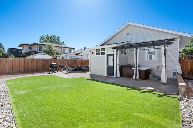 rear view of property with a yard and a patio