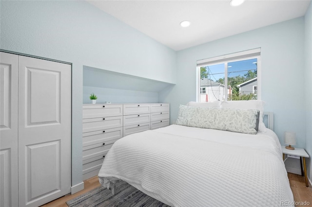 bedroom featuring a closet and light hardwood / wood-style flooring