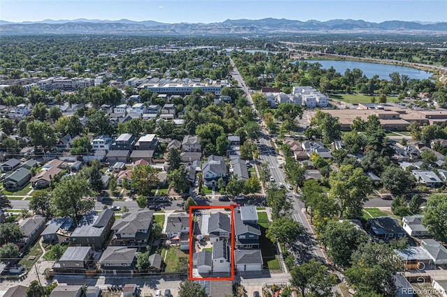 birds eye view of property with a water and mountain view