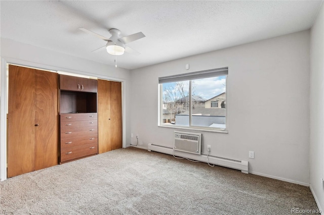 unfurnished bedroom with carpet flooring, a textured ceiling, baseboard heating, and a closet