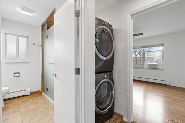 laundry room with cooling unit, stacked washer and clothes dryer, and baseboard heating