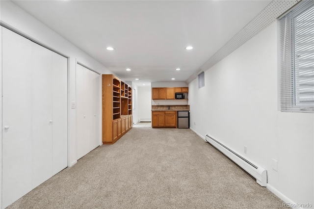 unfurnished living room featuring a baseboard radiator and light carpet