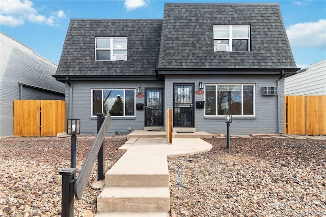 view of front of property featuring an AC wall unit