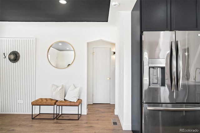 kitchen featuring light wood-type flooring and stainless steel fridge with ice dispenser