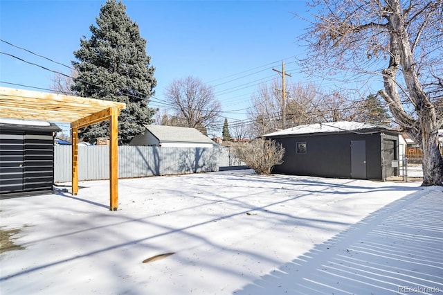 yard layered in snow with a pergola