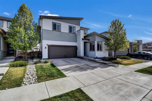 18085 E 107th Pl, Commerce City, CO 80022 - contemporary house featuring concrete driveway and a garage