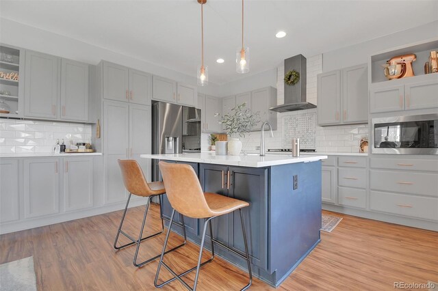 18085 E 107th Pl, Commerce City, CO 80022 - kitchen with wall chimney range hood, gray cabinetry, decorative backsplash, built in microwave, and recessed lighting