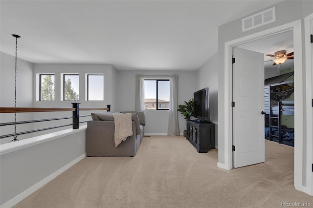 18085 E 107th Pl, Commerce City, CO 80022 - living room with light colored carpet, baseboards, and a ceiling fan