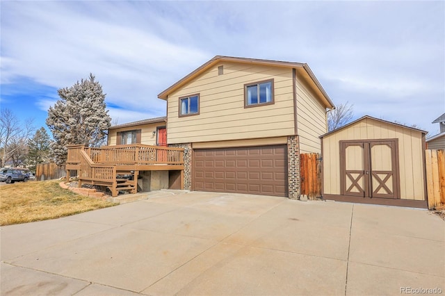 view of front facade featuring a wooden deck, a storage shed, and a garage