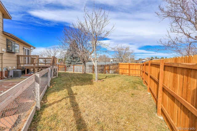 view of yard with central AC and a deck