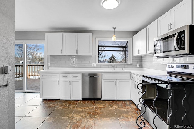 kitchen with sink, white cabinets, and appliances with stainless steel finishes