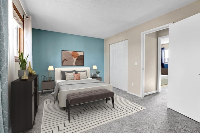 bedroom with carpet flooring, a textured ceiling, and a closet