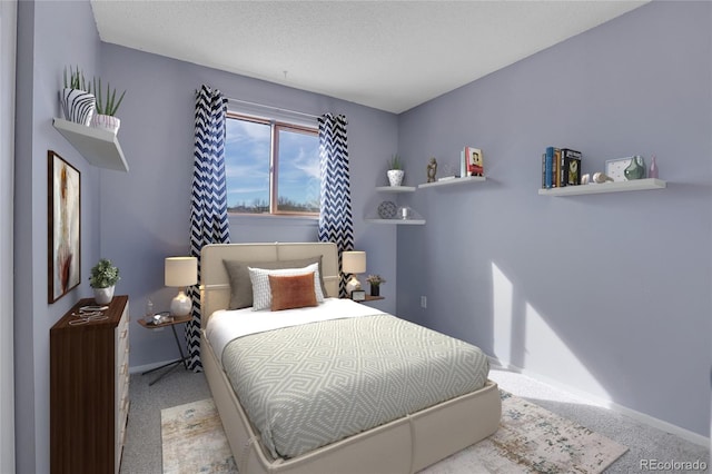 bedroom with light carpet and a textured ceiling