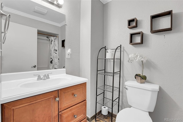 bathroom featuring vanity, crown molding, and toilet