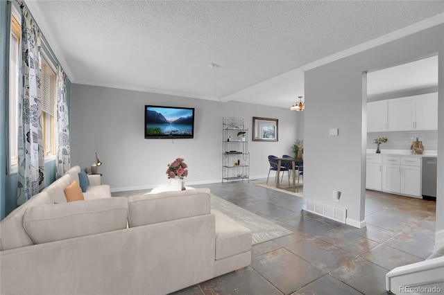 living room featuring ornamental molding and a textured ceiling