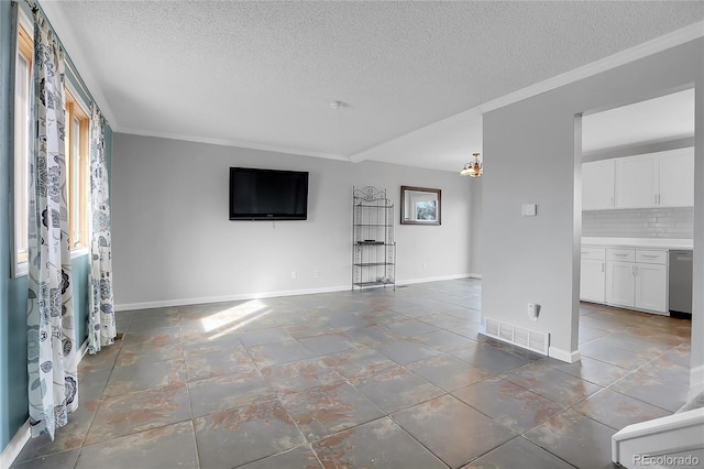 unfurnished living room with crown molding, a wealth of natural light, and a textured ceiling