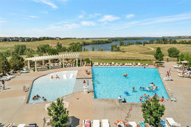 view of swimming pool featuring a pergola, a water view, and a patio