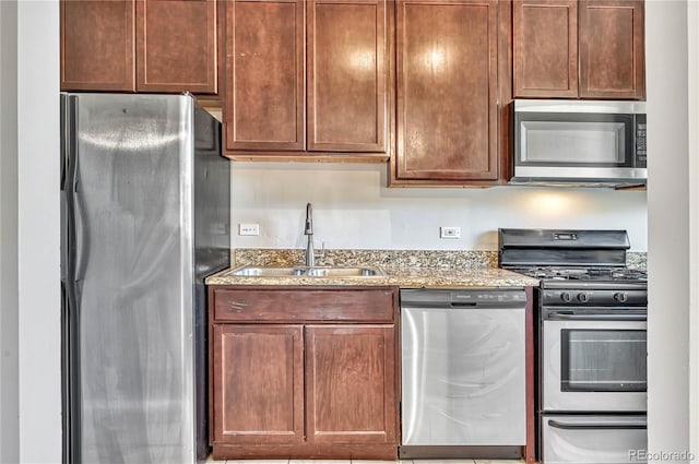 2100 N Franklin St Unit 15, Denver, CO 80205 - kitchen with stainless steel appliances, a sink, and light stone countertops