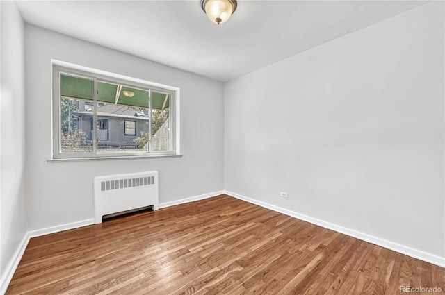 2100 N Franklin St Unit 15, Denver, CO 80205 - unfurnished room featuring radiator, wood finished floors, and baseboards