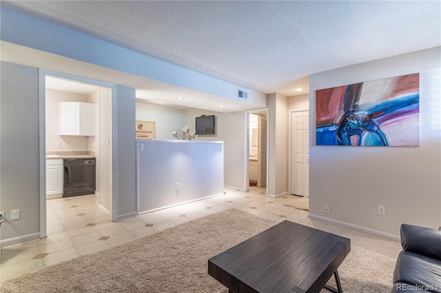 living room featuring light tile patterned floors and a textured ceiling