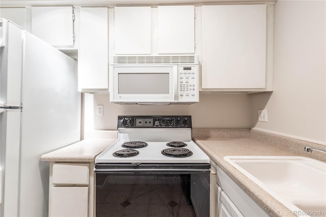 kitchen featuring white cabinets, white appliances, sink, and tile patterned floors