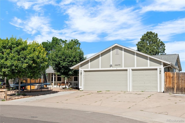 16673 E Kent Dr, Aurora, CO 80013 - view of front of home with a garage, driveway, roof with shingles, and stucco siding