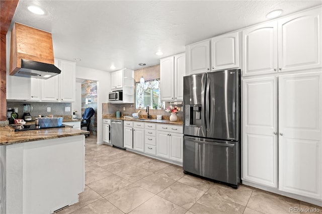 16673 E Kent Dr, Aurora, CO 80013 - kitchen featuring stainless steel appliances, dark stone counters, tasteful backsplash, light tile patterned floors, and white cabinets
