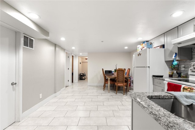 16673 E Kent Dr, Aurora, CO 80013 - kitchen with range hood, white appliances, recessed lighting, tasteful backsplash, and light stone countertops