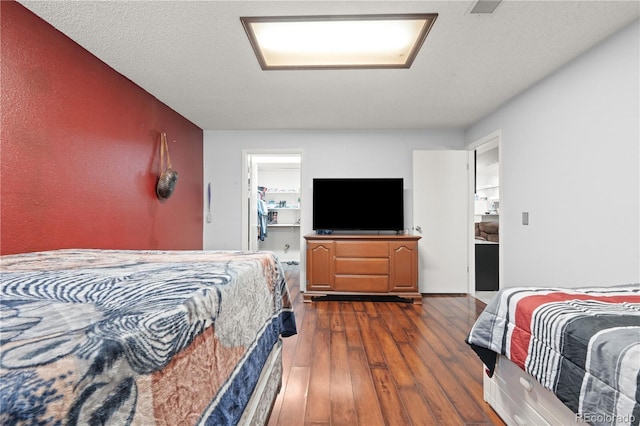 16673 E Kent Dr, Aurora, CO 80013 - bedroom featuring dark wood-style flooring and a spacious closet