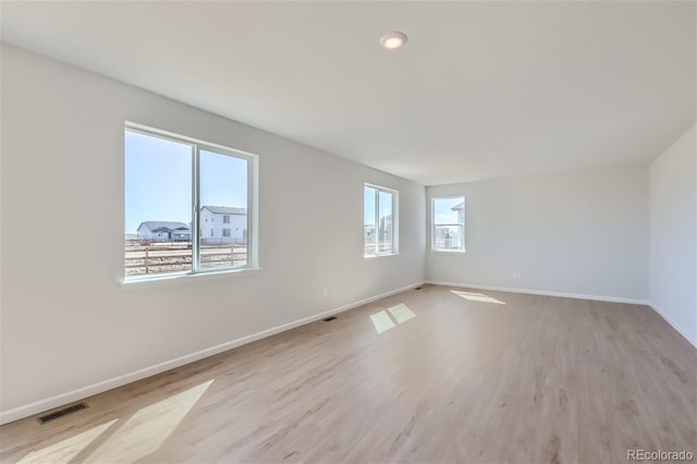 empty room with light hardwood / wood-style floors