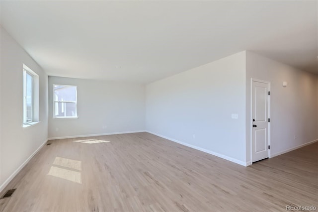 spare room featuring light wood-type flooring