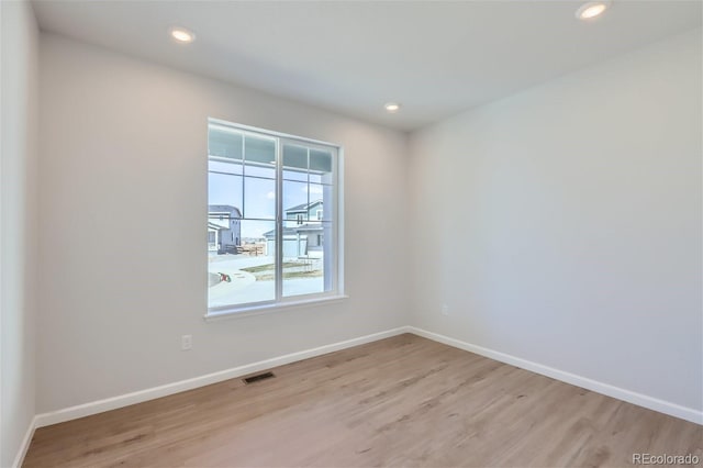 spare room featuring light hardwood / wood-style flooring