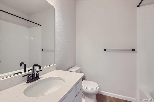 full bathroom with hardwood / wood-style flooring, vanity, toilet, and shower / bathing tub combination