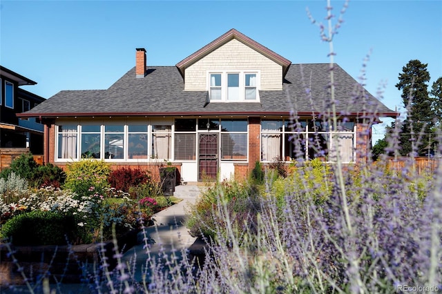 2096 S Logan St, Denver, CO 80210 - rear view of property featuring a chimney, roof with shingles, and brick siding