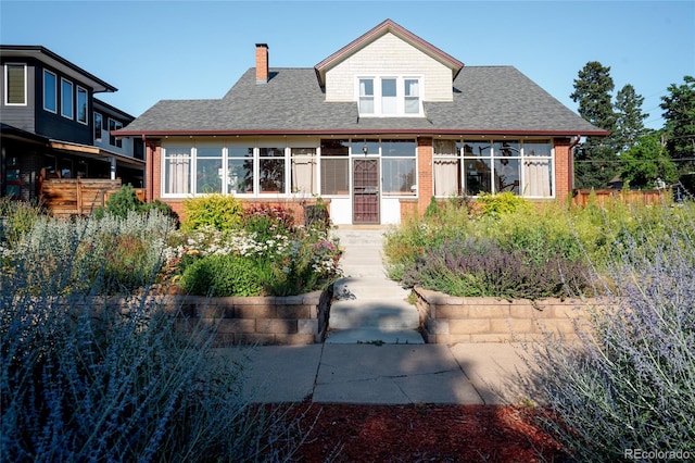 2096 S Logan St, Denver, CO 80210 - view of front of property with a chimney, brick siding, and a shingled roof