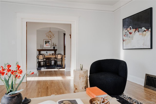 2096 S Logan St, Denver, CO 80210 - sitting room with wood finished floors, ornamental molding, and arched walkways