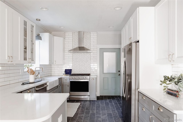 2096 S Logan St, Denver, CO 80210 - kitchen featuring stainless steel appliances, wall chimney exhaust hood, tasteful backsplash, light countertops, and recessed lighting