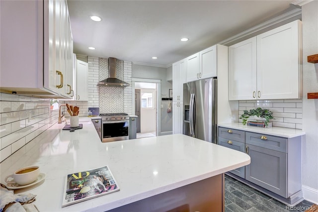 2096 S Logan St, Denver, CO 80210 - kitchen with wall chimney range hood, stainless steel appliances, gray cabinets, backsplash, and light stone counters