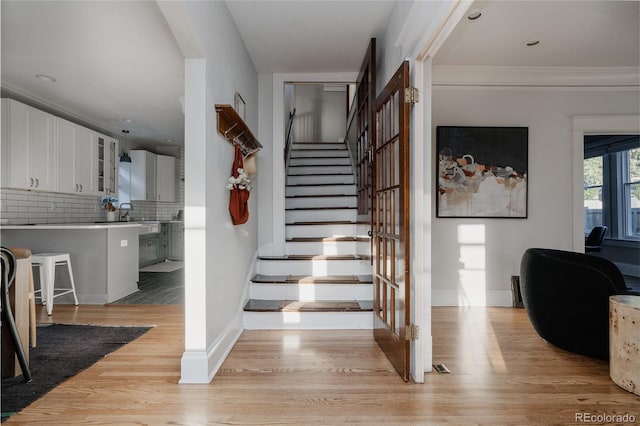 2096 S Logan St, Denver, CO 80210 - stairway featuring wood finished floors and crown molding