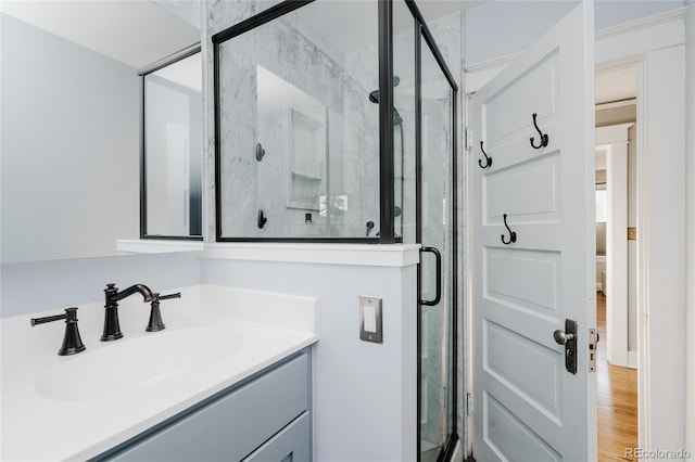 2096 S Logan St, Denver, CO 80210 - bathroom featuring a shower stall, vanity, and wood finished floors