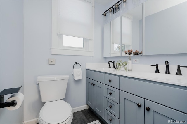 2096 S Logan St, Denver, CO 80210 - bathroom featuring baseboards and double vanity