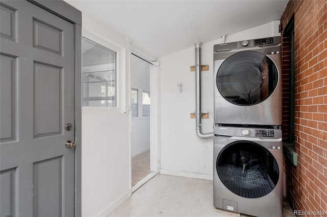 2096 S Logan St, Denver, CO 80210 - laundry area featuring stacked washer / drying machine and brick wall