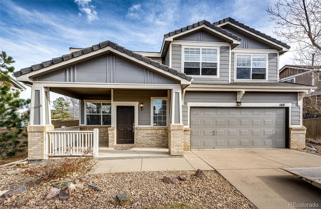 craftsman house featuring covered porch and a garage