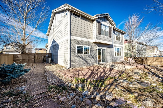 rear view of property featuring a patio area and cooling unit