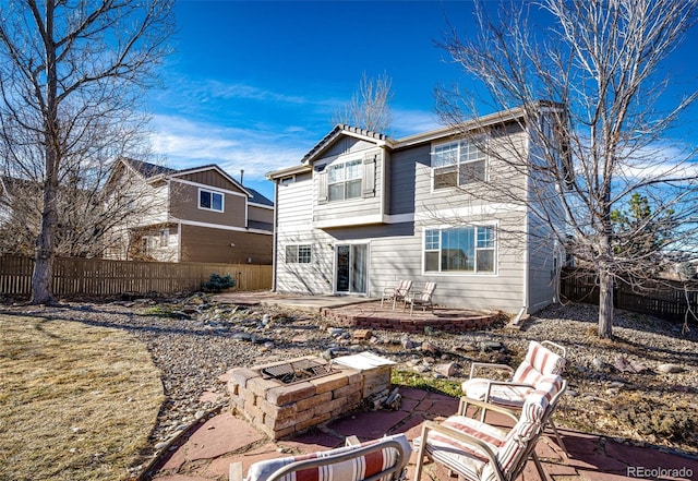 rear view of house featuring a patio area and an outdoor fire pit