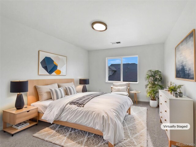 bedroom with baseboards, light carpet, and visible vents