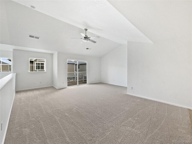 unfurnished living room with visible vents, lofted ceiling, baseboards, ceiling fan, and carpet flooring