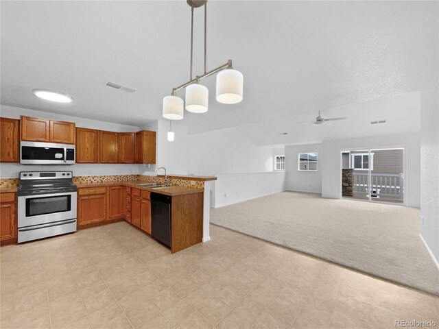 kitchen featuring a sink, brown cabinets, light carpet, and stainless steel appliances
