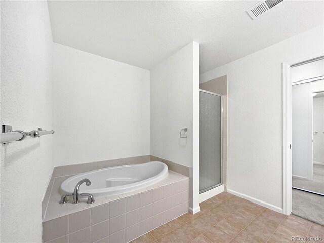full bath with tile patterned floors, baseboards, a shower stall, visible vents, and a garden tub